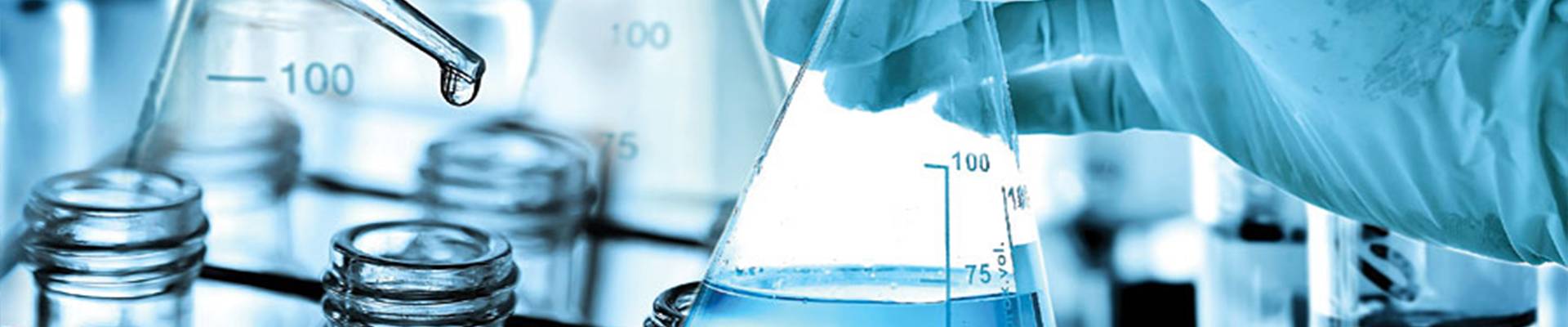 The researcher is dripping the liquid into the flask.)